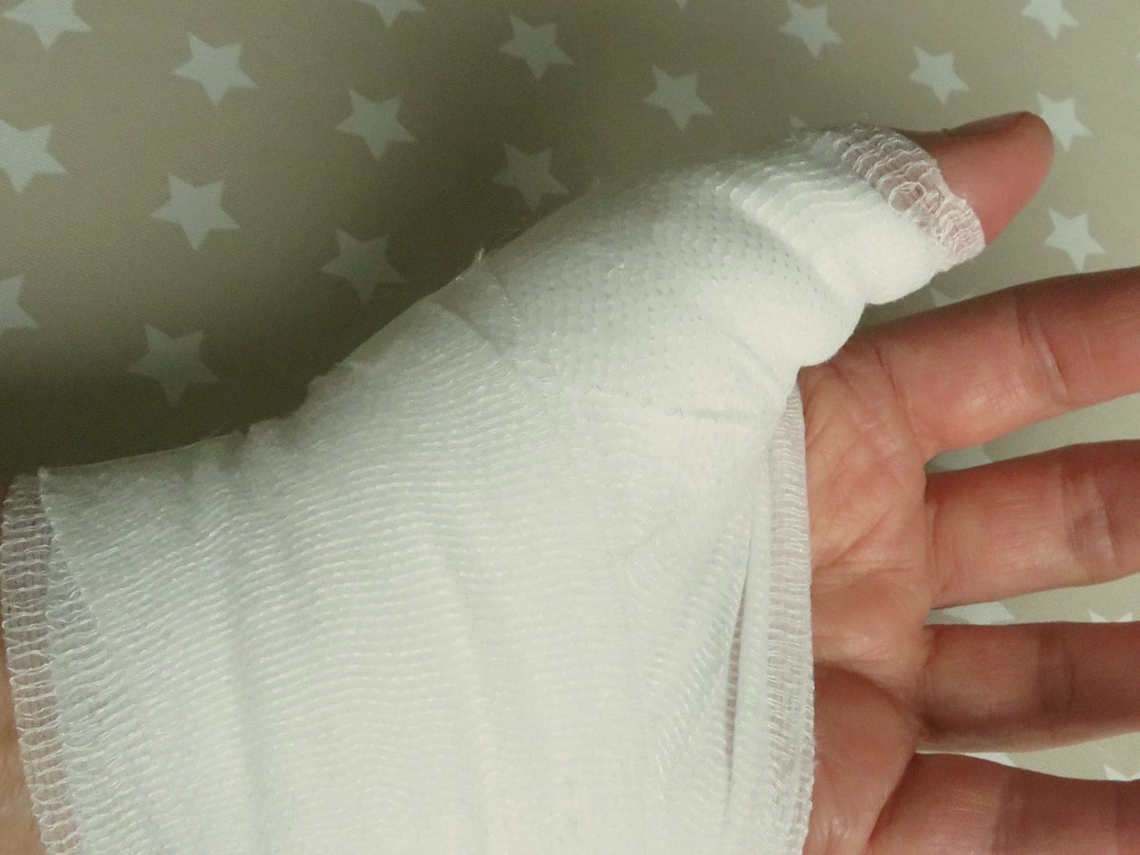 A hand and wrist wrapped in a fresh gauze bandage